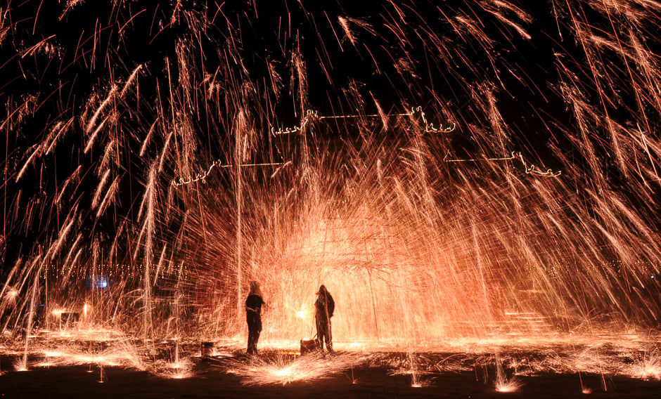 Folk artists perform the art of making shower of melted iron sparks at a celebrations event in Anyang, Henan province, China. PHOTO: REUTERS