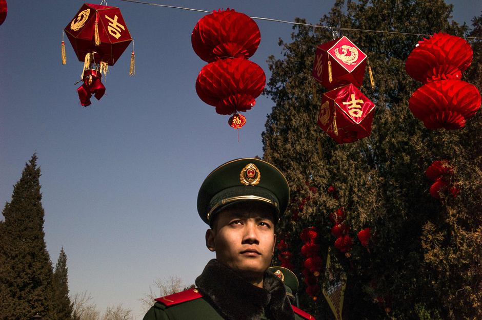 A paramilitary guard walks under red lanterns at a temple fair in Ditan Park during Lunar New Year celebrations in Beijing. PHOTO: AFP