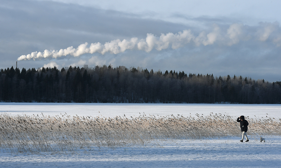 A stroller walks at a frozen lake near near the city of Lahti, Finland. PHOTO: AFP
