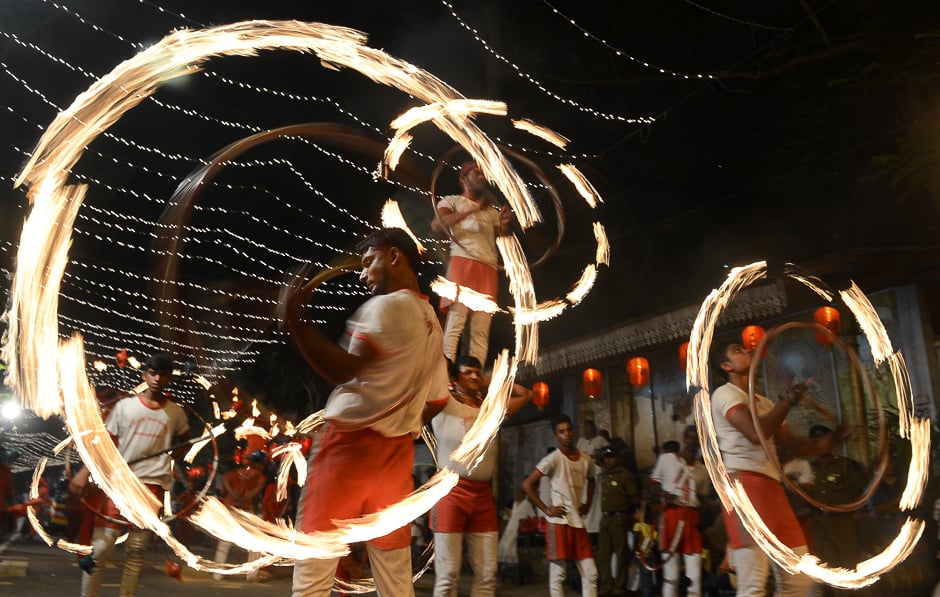 Fire dancers perform in a procession. PHOTO: AFP