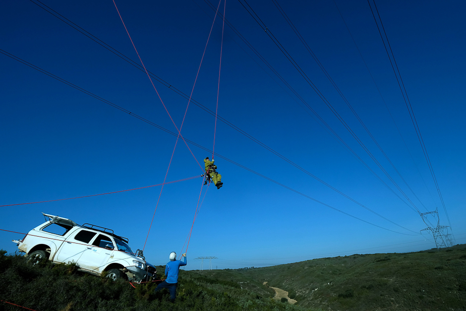 Technicians from the RTE (Reseau de Transport d'Electricite) install a sensor, capable of measuring the cooling effect of the mistral on a high-voltage line, on a 400,000 volt power line in Aix-en-Provence. PHOTO: AFP