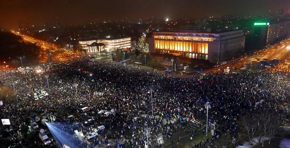 Protesters gather in front of the government building during a protest in Victoriei Square, in Bucharest, Romania. PHOTO: REUTERS