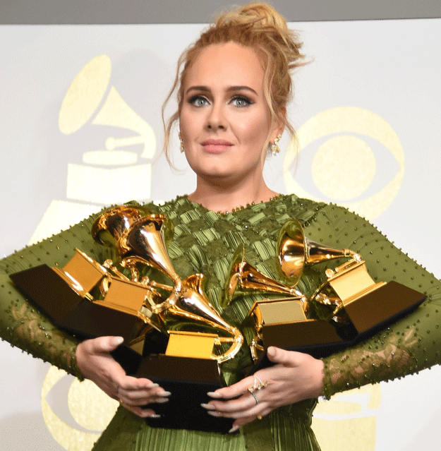 Adele poses in the press room with her trophies