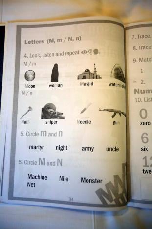 An English textbook found in an Islamic State facility for child fighters, which includes military vocabulary alongside ordinary words, is pictured in Mosul, Iraq, February 16, 2017. PHOTO: REUTERS