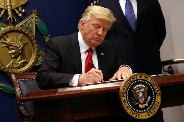 US President Donald Trump signs an executive order to impose tighter vetting of travelers entering the United States, at the Pentagon in Washington, US PHOTO: REUTERS 