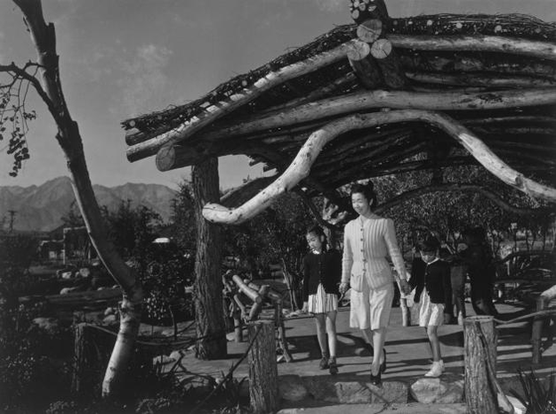 Mrs Yaeko Nakamura, holding hands with her two daughters, Joyce Yuki Nakamura and Louise Tami Nakamura, walk under a pavilion in a park at the Manzanar War Relocation Centre in California, in this 1943 handout photo. PHOTO: REUTERS