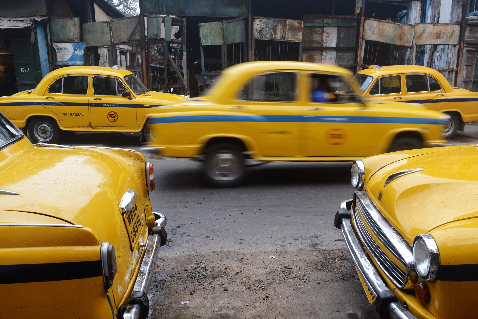A fleet of yellow Hindustan Ambassador taxis on a street in the capital of West Bengal. Indiaâs Hindustan Motors has sold its Ambassador car division to Peugeot for Â£9.6m, Kolkata, India. PHOTO: AFP