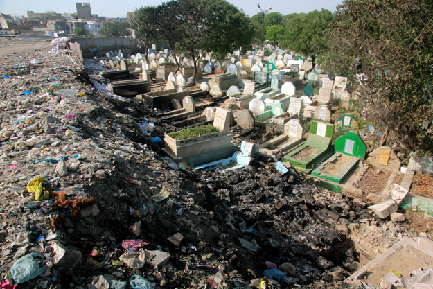 The graveyard is littered with garbage but the authorities are turning a blind eye. PHOTO: ATHAR KHAN/EXPRESS
