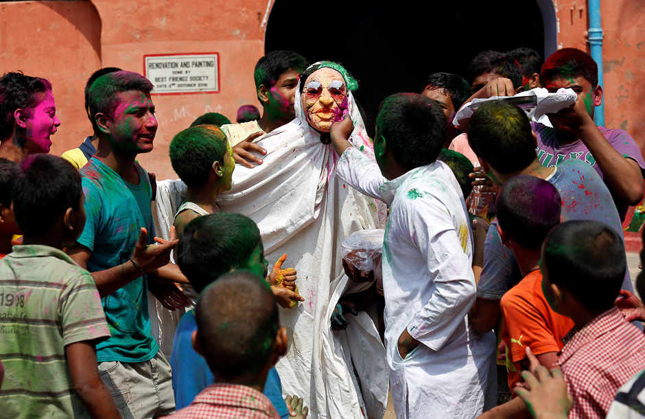 Boys smear each other with colours, Kolkata, India. PHOTO: REUTERS