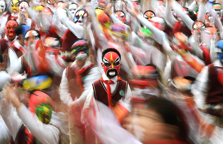 Students wearing traditional opera masks attend an exercise session in Wuhan, Hubei province, China. PHOTO: REUTERS