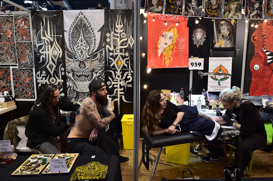 Visitors get tattooed during the Tattoo World Fair in Paris. PHOTO: AFP