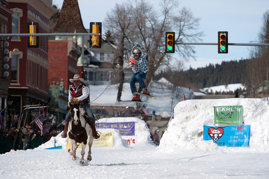 Rider Jeff Dahl races down Harrison Avenue while skier and son Greg Dahl airs out off the final jump of the Leadville skijoring course during the 68th annual Leadville Ski Joring weekend competition. PHOTO: AFP