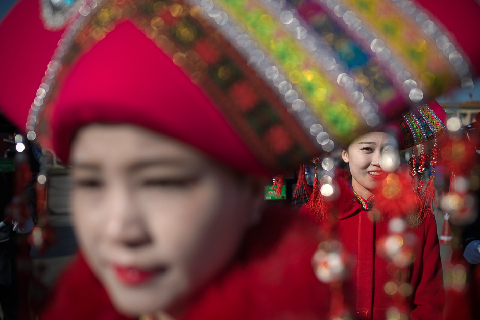Hostesses are seen on Tiananmen Square during the opening of the National People's Congress in Beijing. PHOTO: AFP
