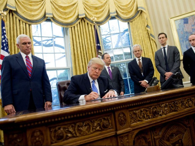  This file photo taken on January 23, 2017 shows US President Donald Trump signing an executive order alongside White House Chief of Staff Reince Priebus (C), US Vice President Mike Pence (L), National Trade Council Advisor Peter Navarro (3rd R), Senior Advisor Jared Kushner (2nd R) and Senior Policy Advisor Stephen Miller in the Oval Office of the White House in Washington, DC, January 23, 2017. PHOTO: AFP