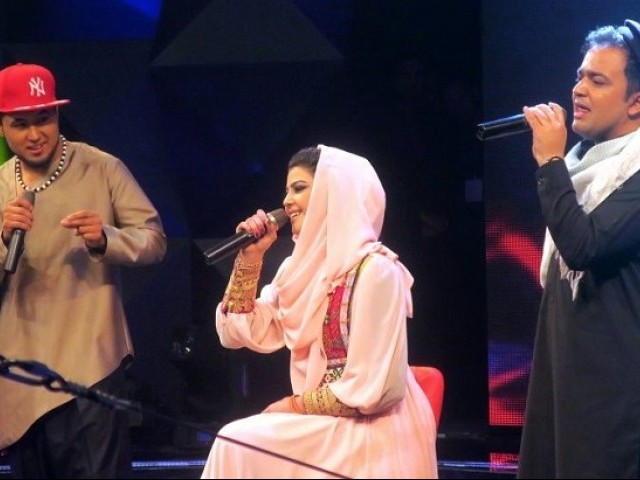 Young Afghan singer Zulala Hashemi performs alongside competitors Sayed Jamal Mubarez (L) and Babak Mohammadi during the television music competition 'Afghan Star', in Kabul. PHOTO: AFP
