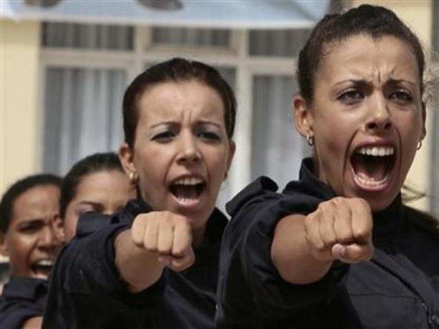 Female police cadets perform during their graduation ceremony at the police academy in Ain Benian August 6, 2009. 
PHOTO: REUTERS