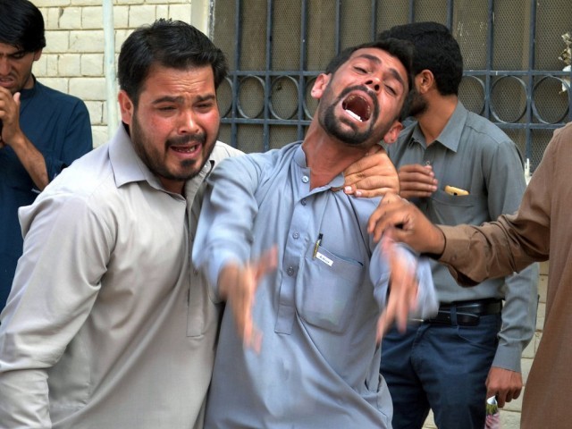 Relatives mourn the dead outside Quetta hospital. PHOTO: AFP