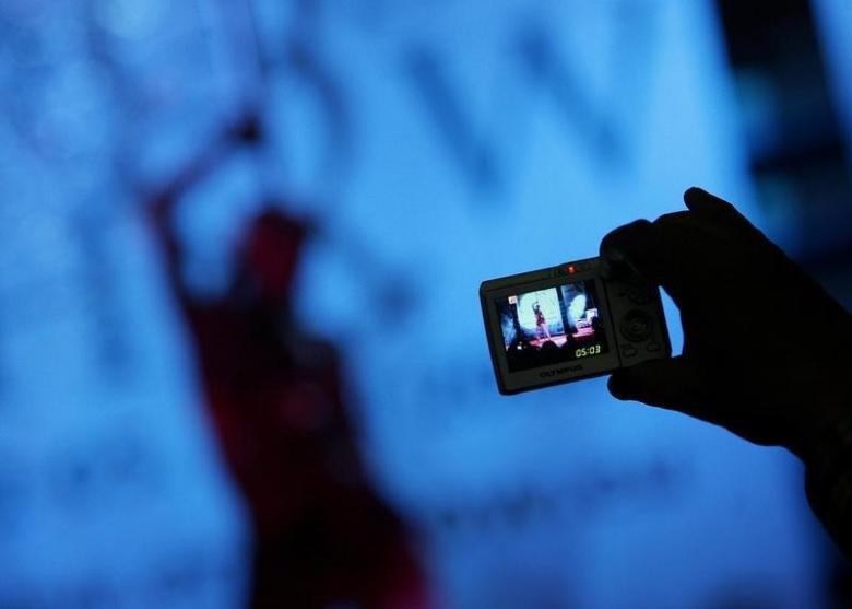 a visitor takes pictures of an adult film actress during the eros show in the bulgarian capital sofia april 2 2008 reuters stoyan nenov