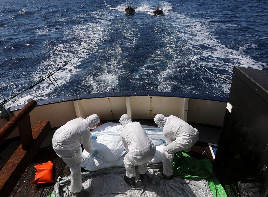 Lifeguards from the Spanish NGO Proactiva Open Arms sanitise five dead bodies of migrants on-board the former fishing trawler Golfo Azzurro following a search and rescue operation in central Mediterranean Sea off the Libyan coast. PHOTO: REUTERS