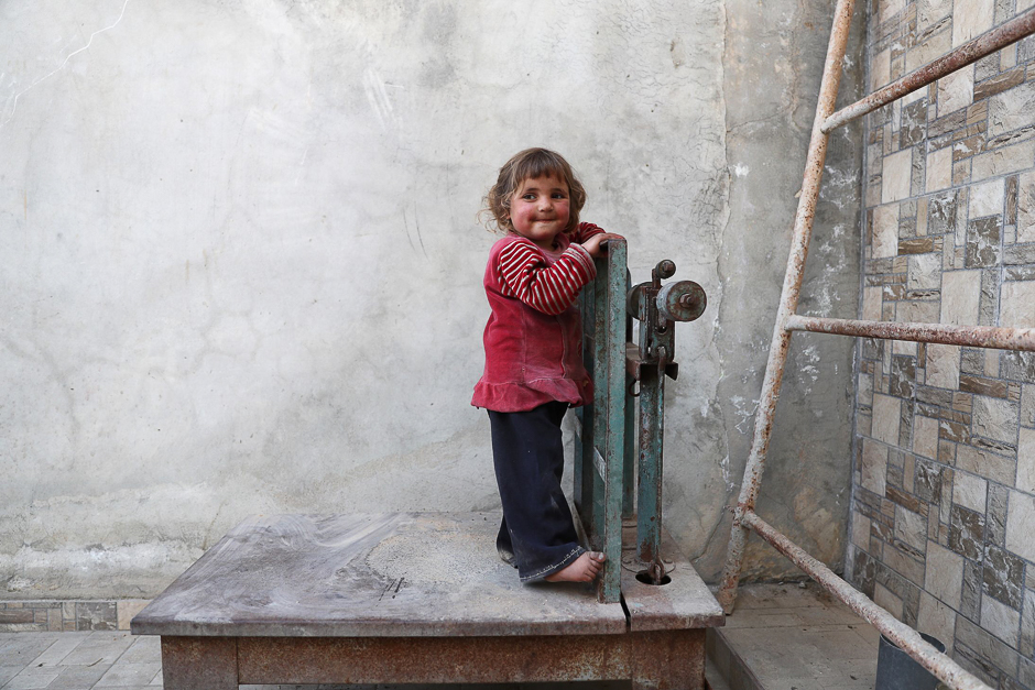 A displaced Syrian girl from the town of Maidaa plays outside her home in the town of Mesraba in the eastern Ghouta region, a rebel stronghold east of the capital Damascus. PHOTO: AFP