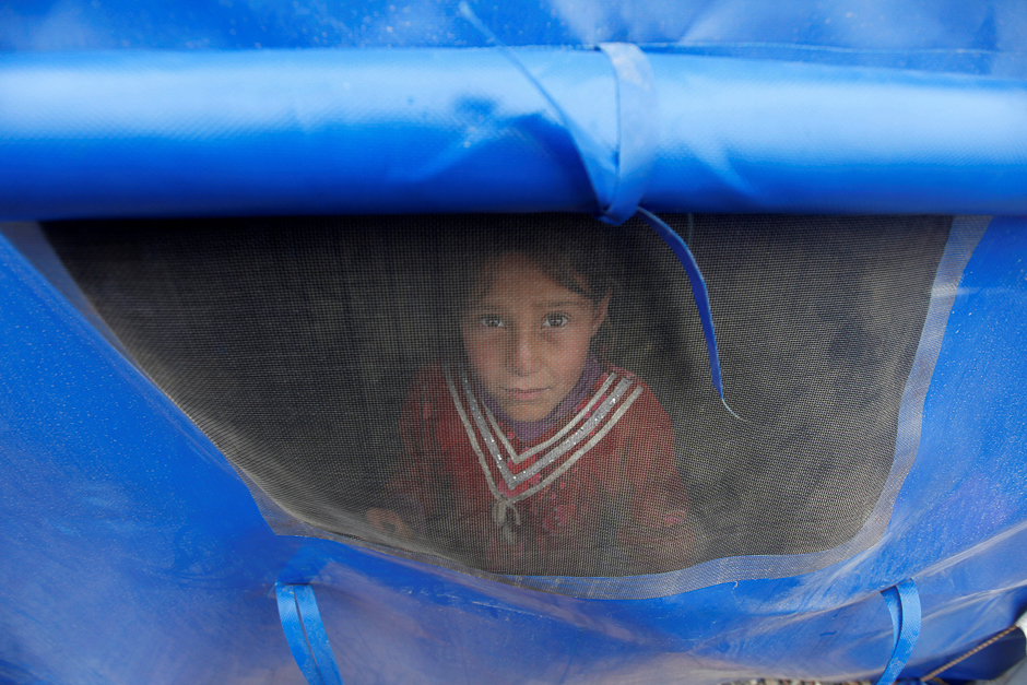 A displaced Iraqi boy who just fled his home waits at a screening centre to be transported to a refugee camp, as Iraqi forces battle with Islamic State militants, in western Mosul, Iraq. PHOTO: REUTERS