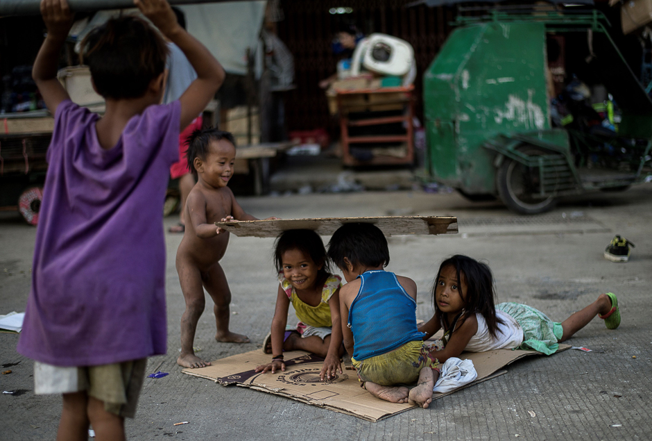 Homeless children play on a street at Divisoria market in Manila. PHOTO: AFP