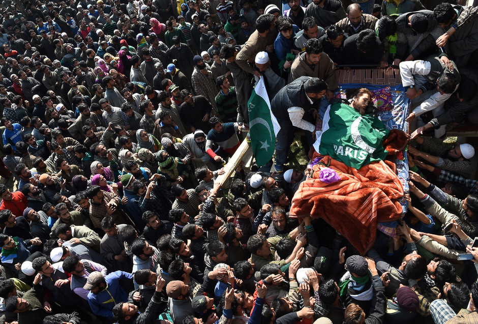 Kashmiri villagers surround the body of suspected rebel Shahbaz Shafi, also known as Rayees Kachroo, at Belov village in Pulwama, south of Srinagar. PHOTO: AFP