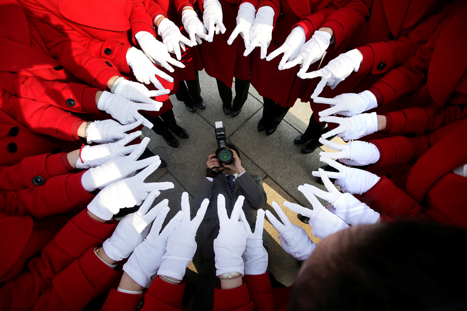 Attendants serving delegates from a hotel pose for a photo at Tiananmen Square as delegates attend a meeting during the annual session of China's parliament, the National People's Congress (NPC), in Beijing, China. PHOTO: REUTERS
