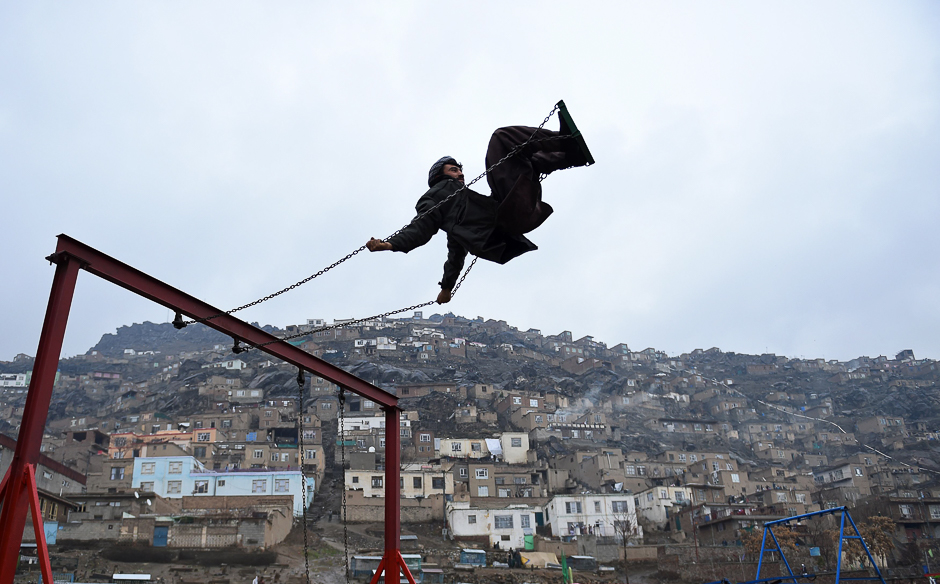 An Afghan man swings on a swing near the Sakhi Shrine during the Nowruz festival to mark the Afghan New Year in Kabul. PHOTO: AFP