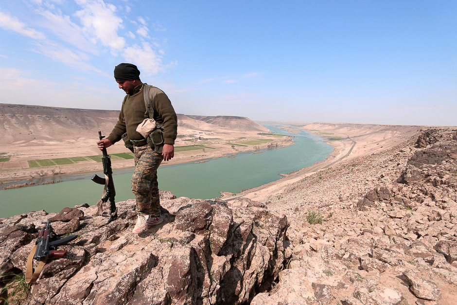 A Syrian Democratic Forces(SDF) fighter poses for a picture near Euphrates River, north of Raqqa city, Syria. PHOTO: REUTERS