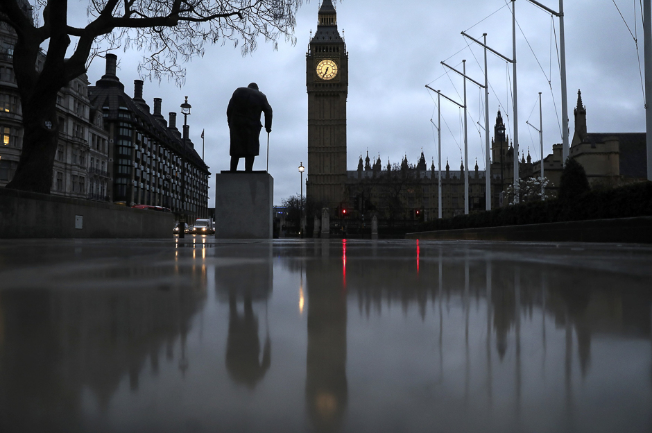 The statue of Winston Churchill and The Houses of Parliament are reflected in the wet pavement in London, Britain. PHOTO: REUTERS