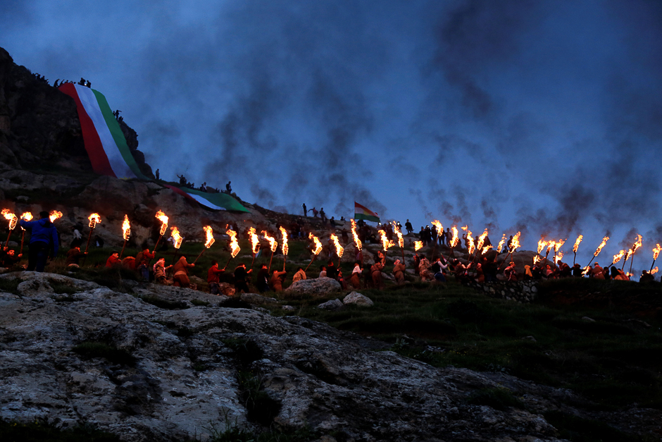 Iraqi Kurdish people carry fire torches up a mountain, as they celebrate Newroz Day, a festival marking their spring and new year, in the town of Akra, Iraq. PHOTO: REUTERS