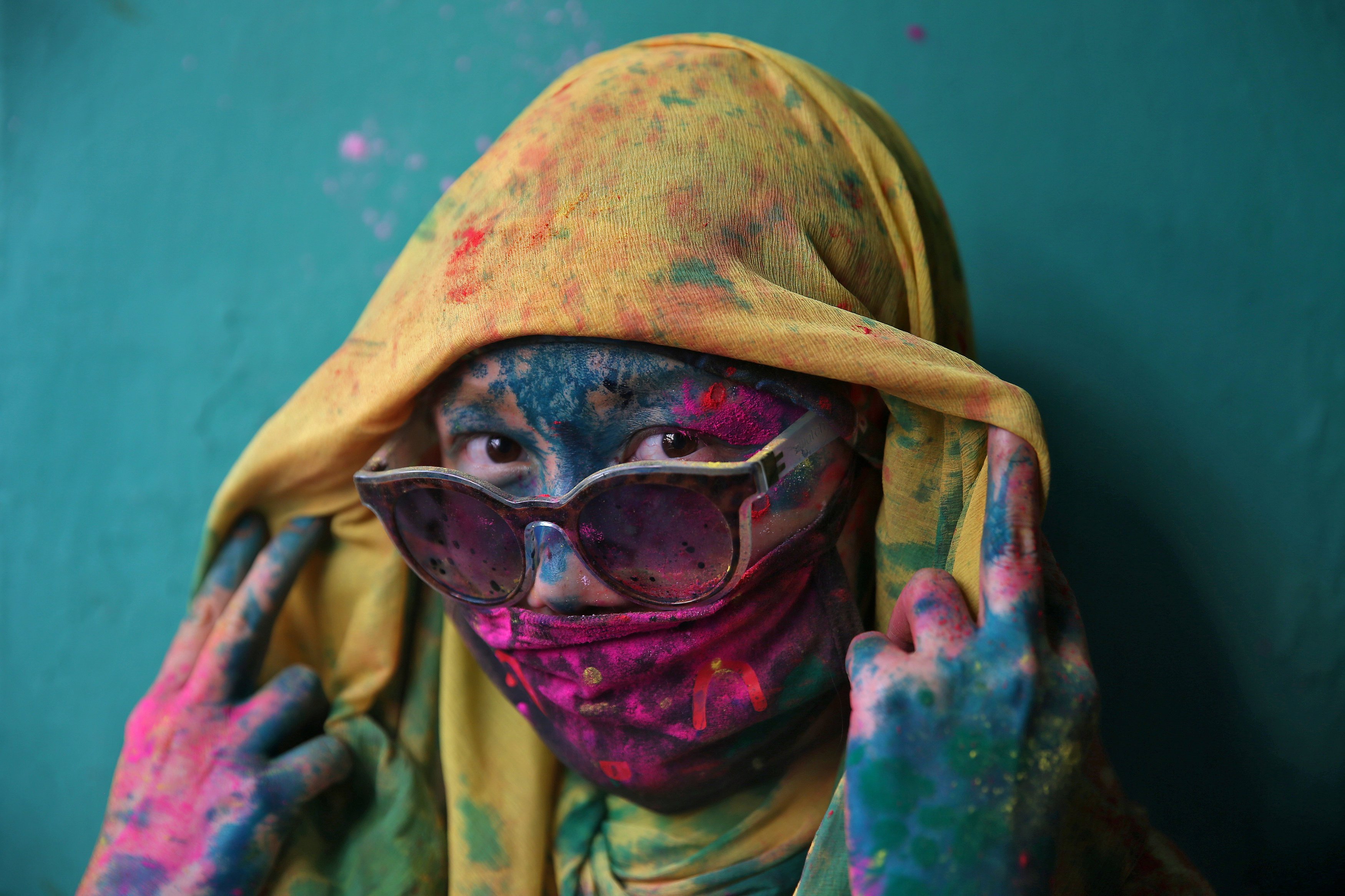 A woman poses for a photograph during Holi celebrations in the town of Barsana in the state of Uttar Pradesh. PHOTO: REUTERS