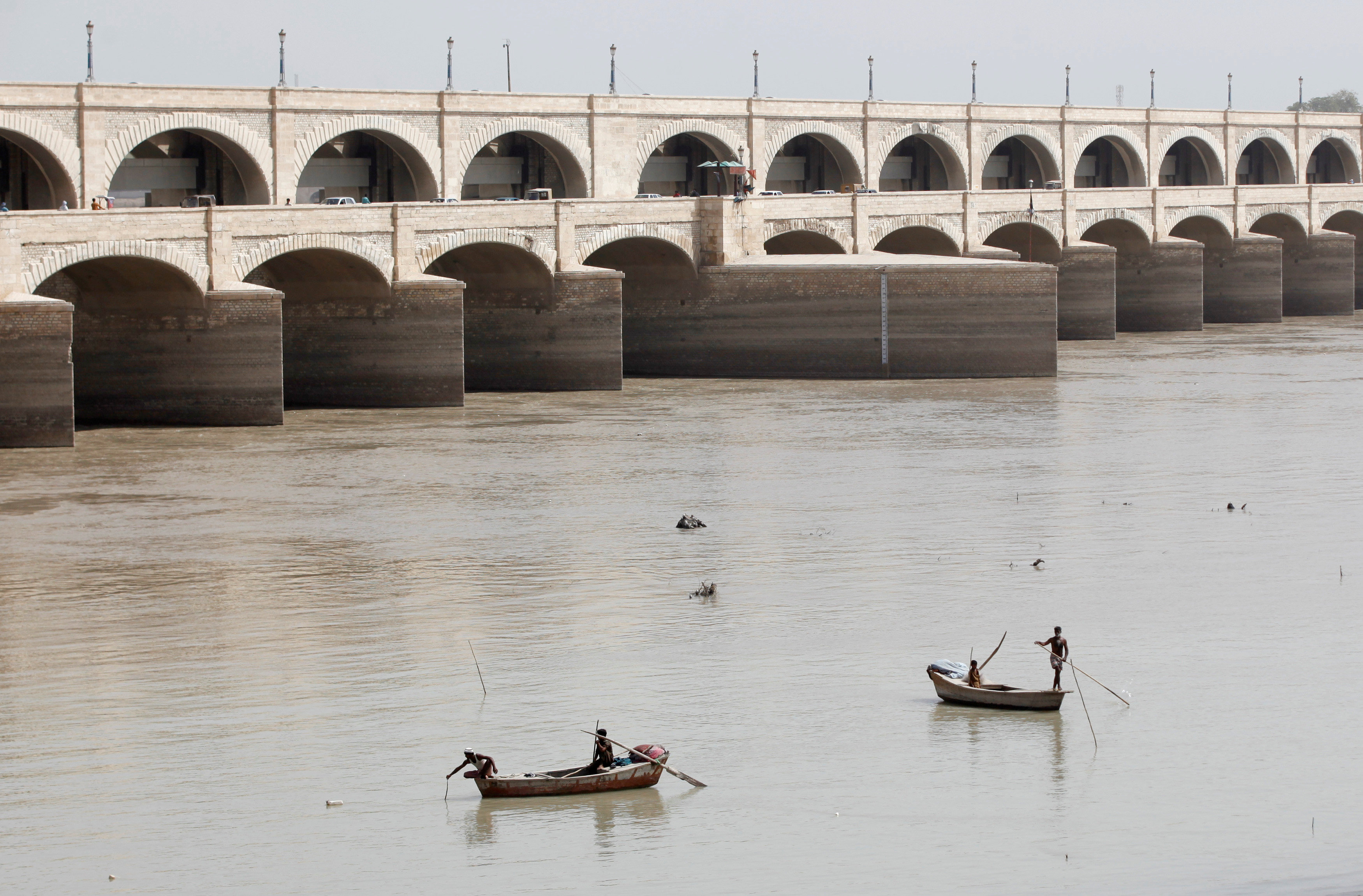 Fishermen row their boats as they catch fish on the river Indus at Sukkur Barrage in Sukkur, Pakistan. PHOTO: REUTERS