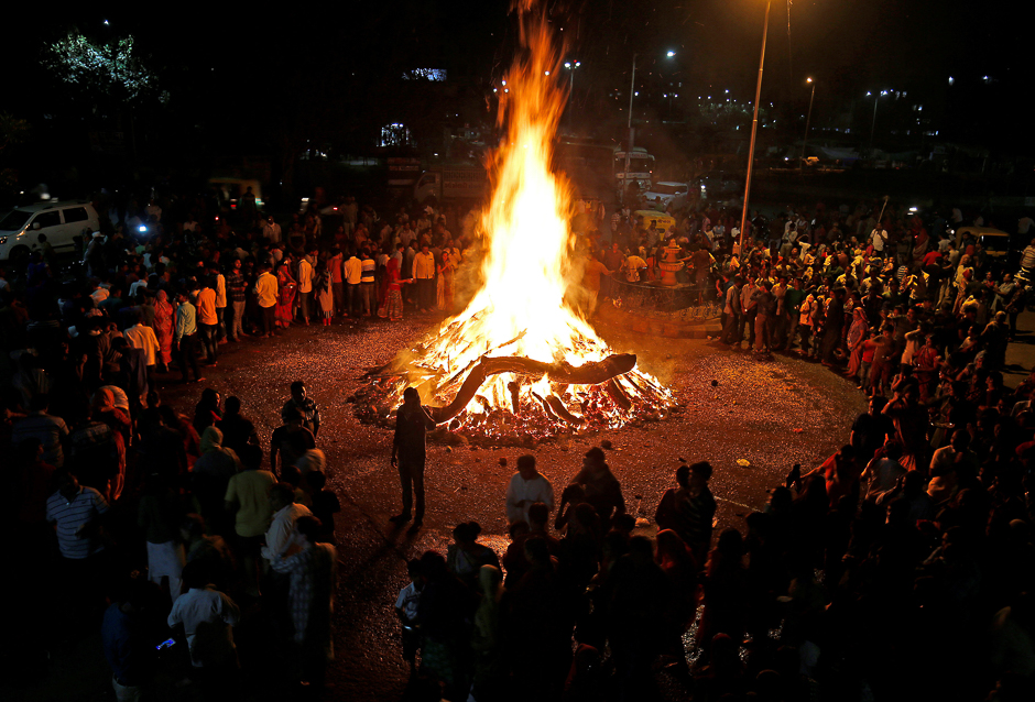 Hindu devotees walk around a bonfire during a ritual known as 