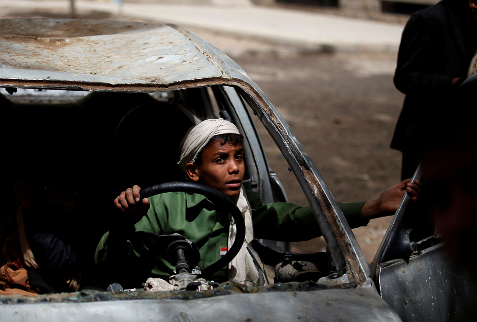 Boys play in an abandoned car in the yard of The al-Shawkani Foundation for Orphans Care in Sanaa, Yemen. PHOTO: REUTERS