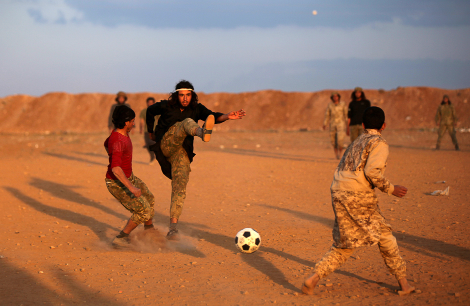 Free Syrian Army fighters play soccer in the northern Syrian town of al-Rai, Syria. PHOTO: REUTERS