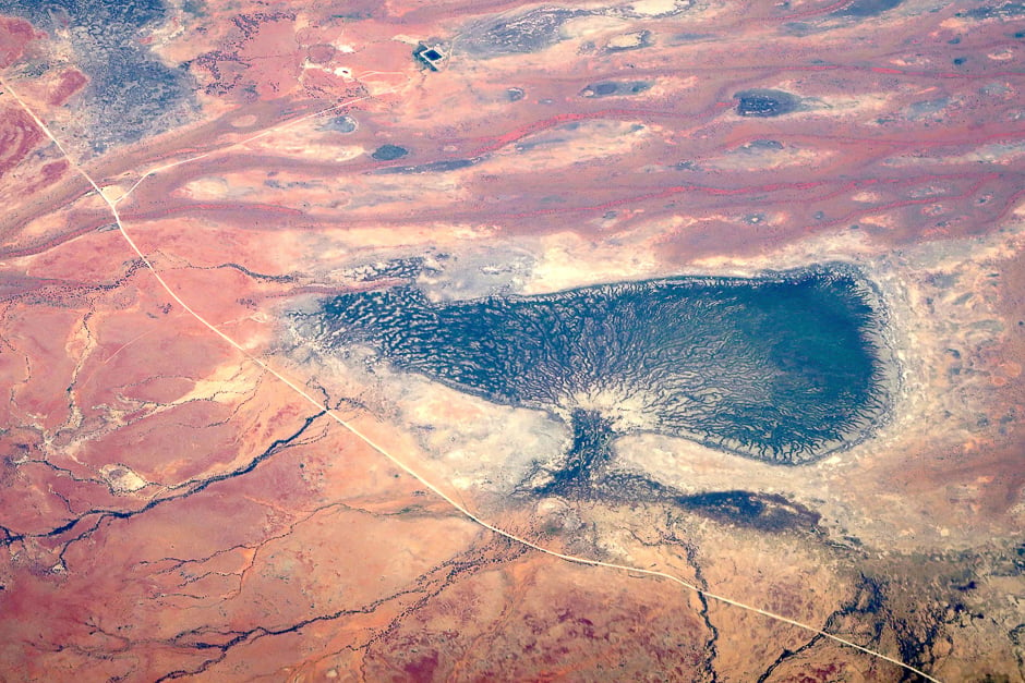 Small dams and a dried-up lake can be seen next to a dirt road in outback Queensland, Australia. PHOTO: REUTERS