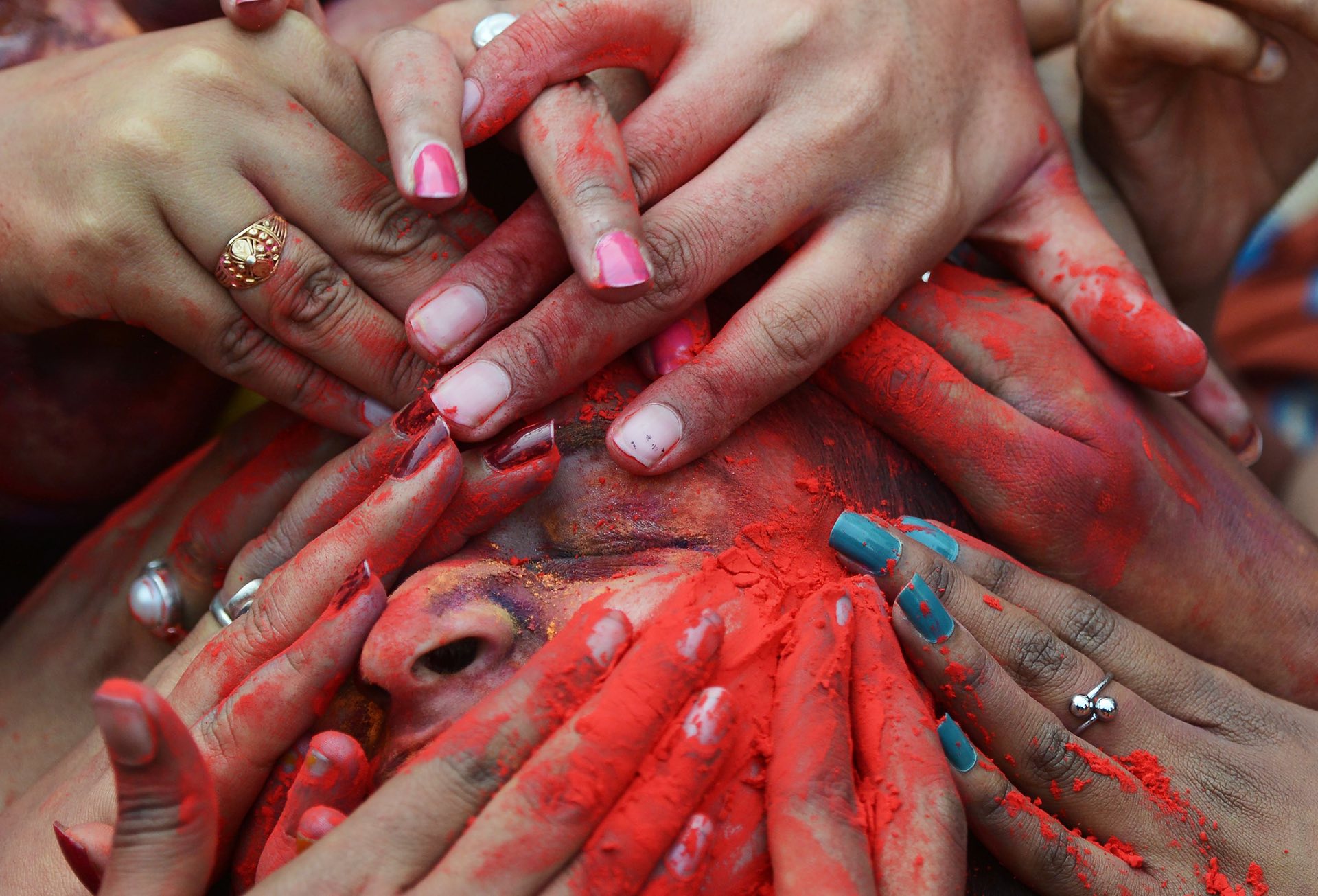 Students at an event in Kolkata smear coloured powder in a spirit of celebration. PHOTO: AFP