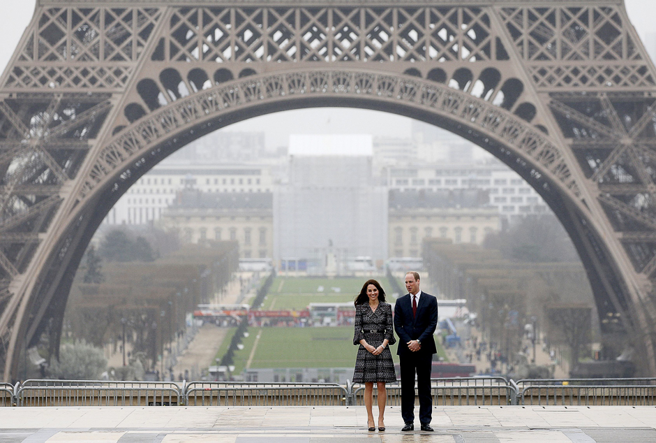 Britain's Prince William, the Duke of Cambridge, and his wife Kate, the Duchess of Cambridge, pose for photographers with the Eiffel tower in background after being welcomed by school children and students from the British Council's Somme project at the Trocadero square, in Paris, France. PHOTO: REUTERS