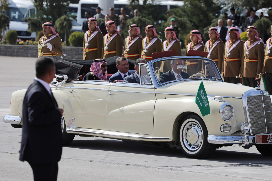 Jordan's King Abdullah II and Saudi Arabia's King Salman bin Abdulaziz Al Saud sit in a car as they pass by honour guards at the airport in Amman, Jordan. PHOTO: REUTERS