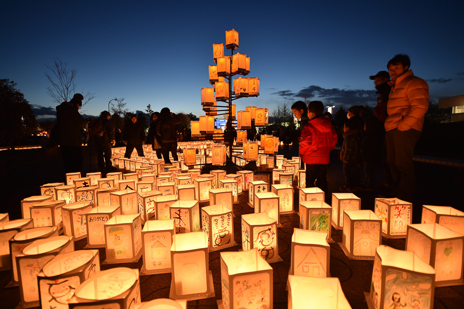 Visitors look at paper lanterns as part of a memorial service for victims of the 2011 quake-tsunami disaster in Natori. PHOTO: AFP