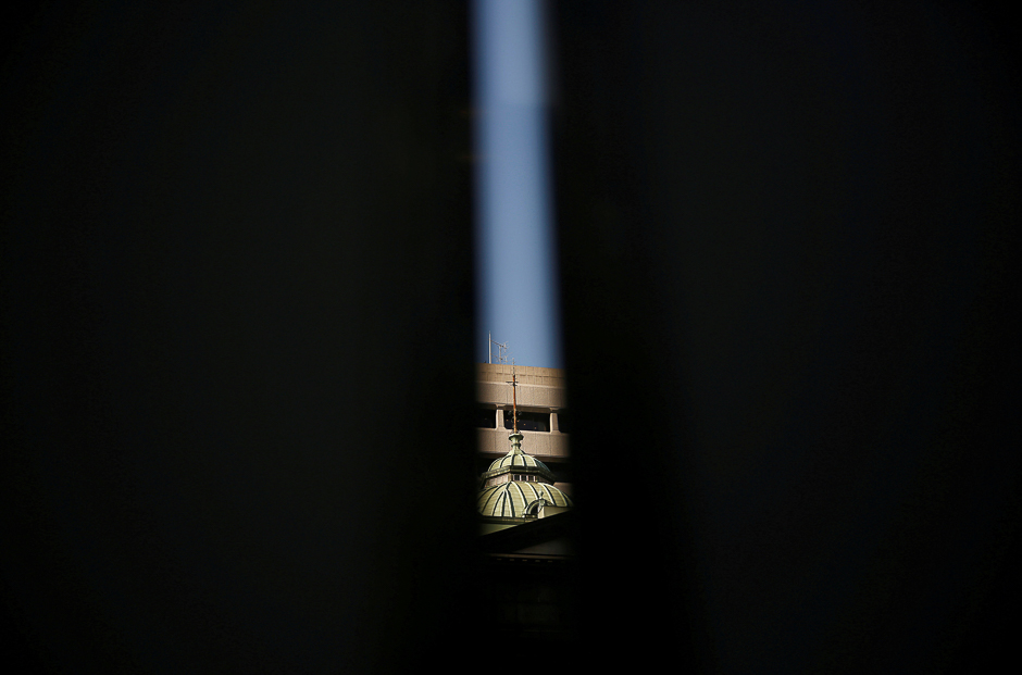 The Bank of Japan building is seen between walls at a construction site in the bank in Tokyo, Japan. PHOTO: REUTERS