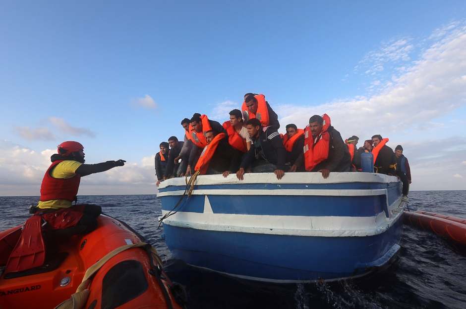 Spanish NGO Proactiva Open Arms rescuers help migrants as hundreds of migrants are seen overcrowding a wooden vessel drifting in central Mediterranean Sea off the Libyan coast. PHOTO: REUTERS