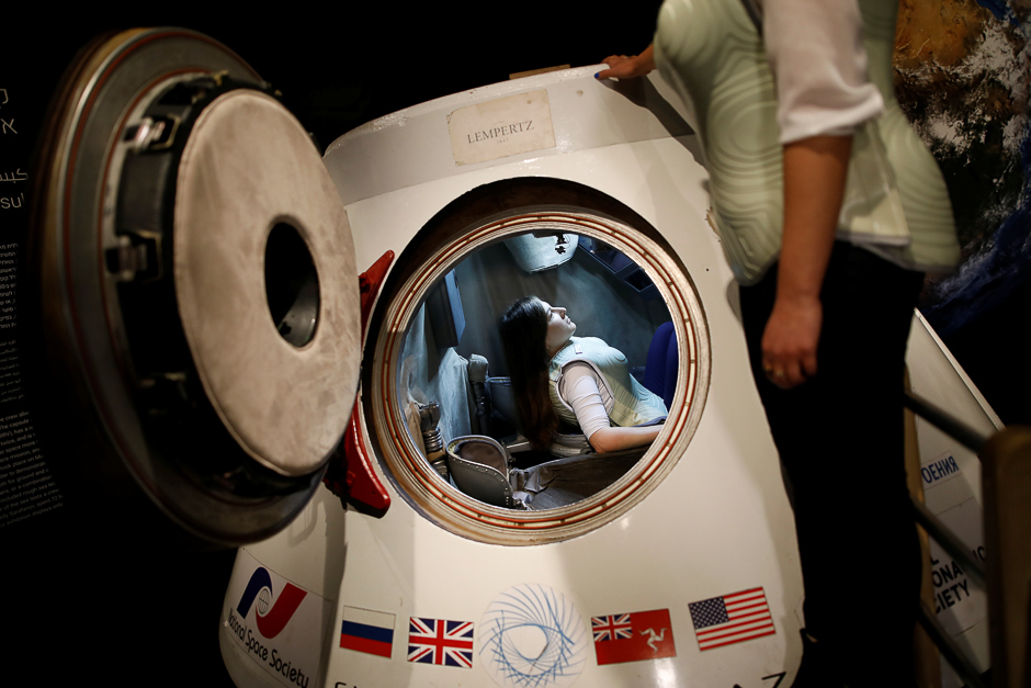 A woman wearing a prototype of Stemrad's new protective vest, Astrorad, sits inside Russian spacecraft, Excalibur-Almaz Space Capsule, during a demonstration for Reuters, at Madatech, National Museum of Science Technology and Space in Haifa, Israel. PHOTO: REUTERS