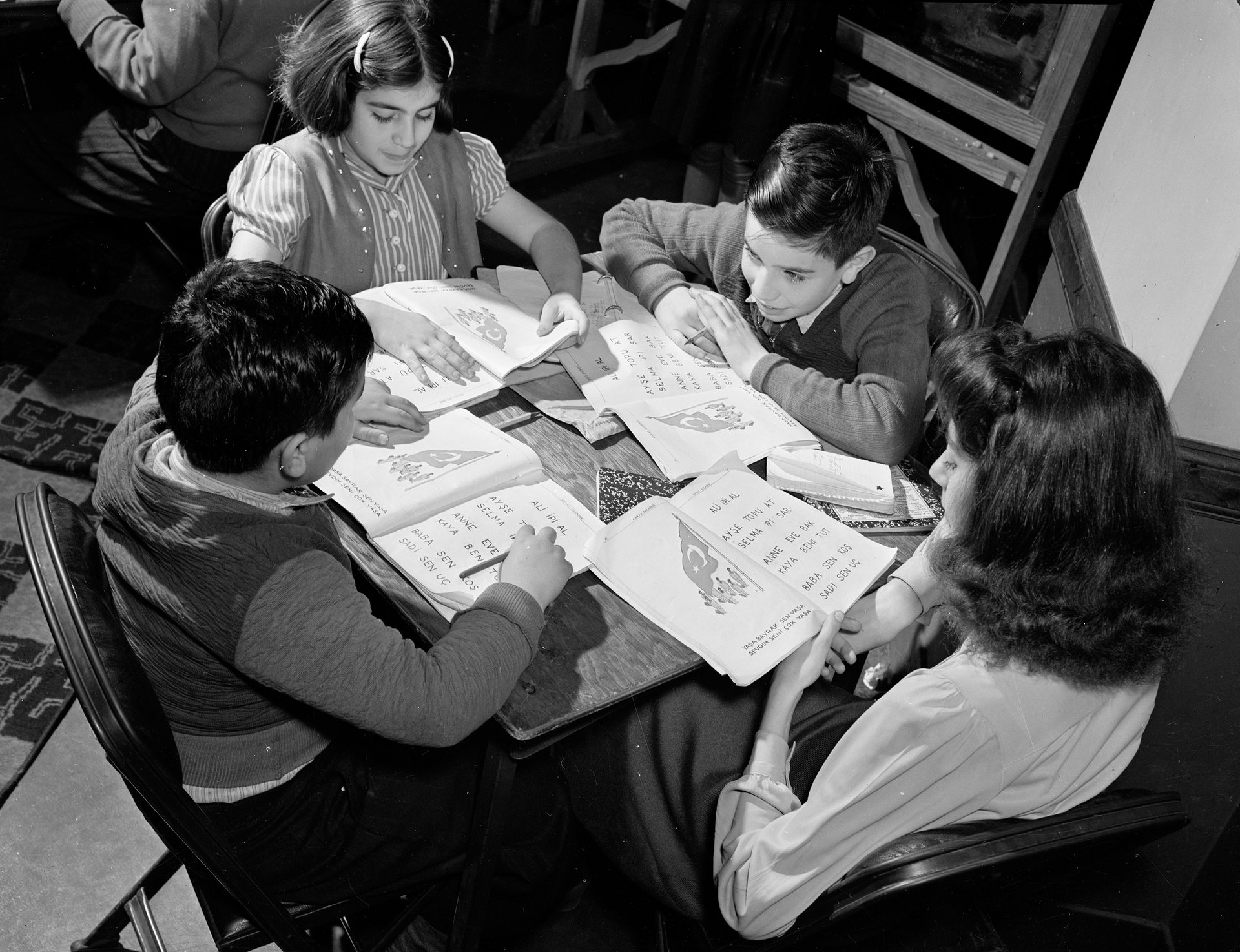 Turkish American children at table with workbooks, ca 1940. PHOTO: ALEXANDER ALLAND