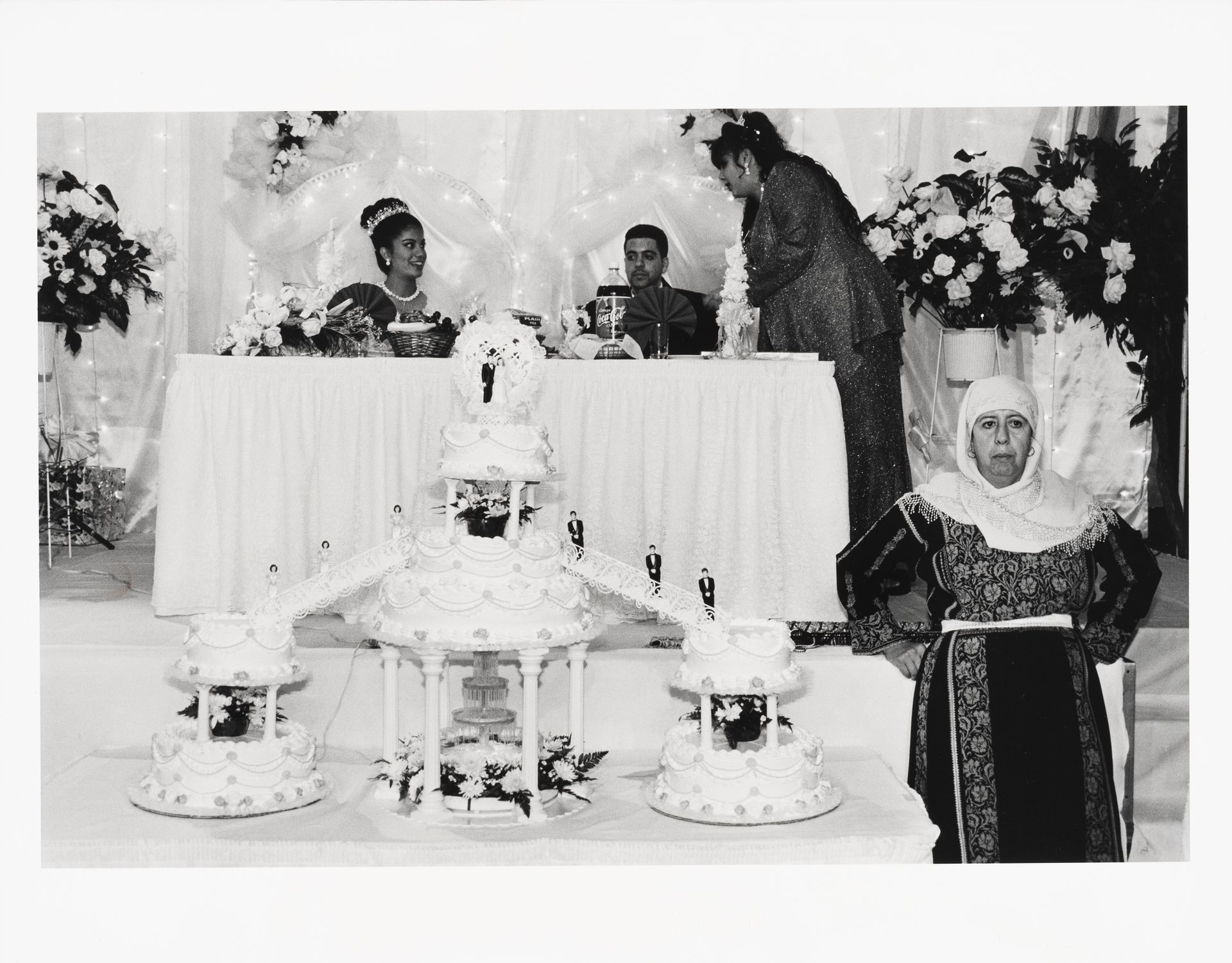 Groomâs mother guarding the wedding cakes at a Palestinian wedding at Widdiâs Catering Hall, 1999. PHOTO: MEL ROSENTHAL 
