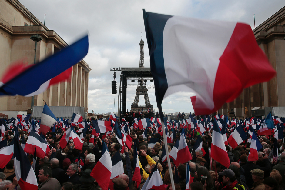 Supporters holding French flags gather for a rally in support of French presidential election candidate for the right-wing Les Republicains (LR) party Francois Fillon at the place du Trocadero, with the Eiffel Tower on the background, in Paris. PHOTO: AFP
