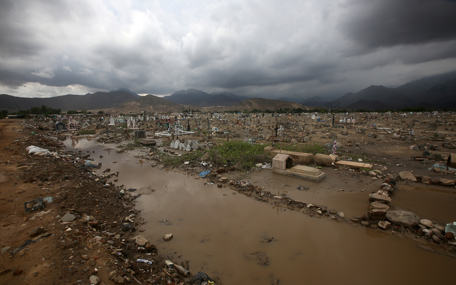 People look at their home damaged by rainfall and flood in Laredo district of Trujillo, northern Peru. PHOTO: REUTERS