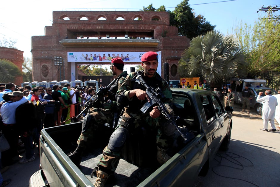 Security personal stand on guard out the Gaddafi Cricket Stadium. PHOTO: REUTERS